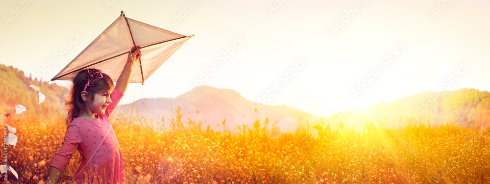 Little Girl With Kite In The Field At Sunset - obrazy, fototapety, plakaty 