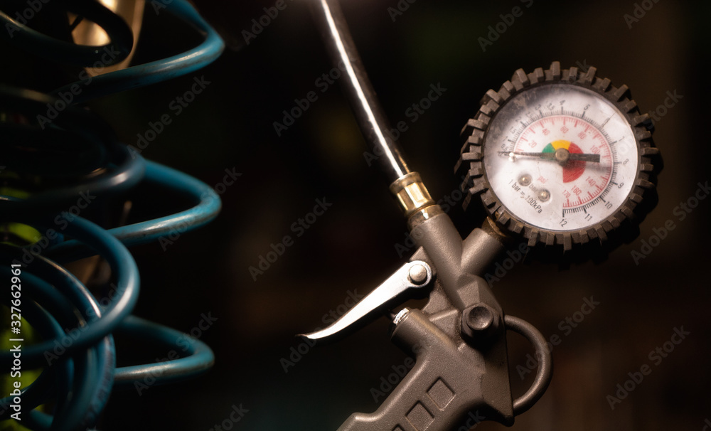 Fototapeta premium Pressure gauge close up in workshop. Selective focus.