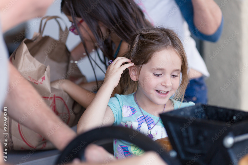 Naklejka premium Kids are helping make fresh apple cider with an apple cider press.