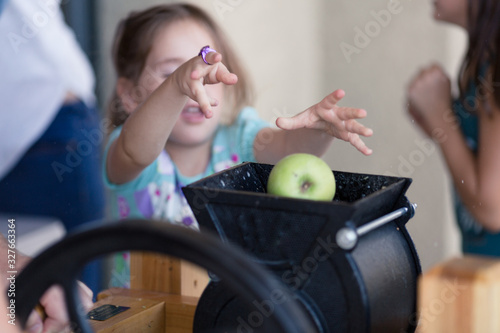Photos Kids are helping make fresh apple cider with an apple cider press