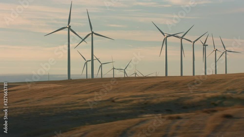 Tracking shot of energy producing wind turbines in Oregon