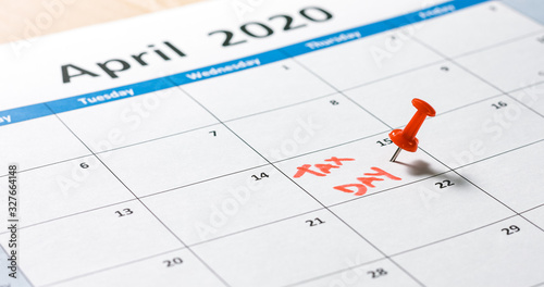 Billede på lærred Writing and pinning tax day on calendar for april 15 with red color