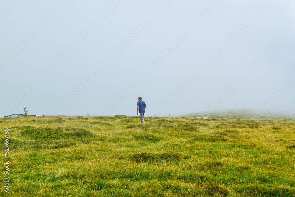 Man near the Transalpina serpentines road DN67C. This is one of the most beautiful alpine routes in Romania.