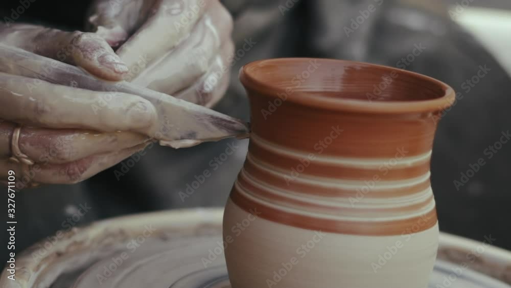 Close-up, Hands of the Potter Woman Cut the Pattern on the Clay Pitcher Rotating on the Pottery Circle