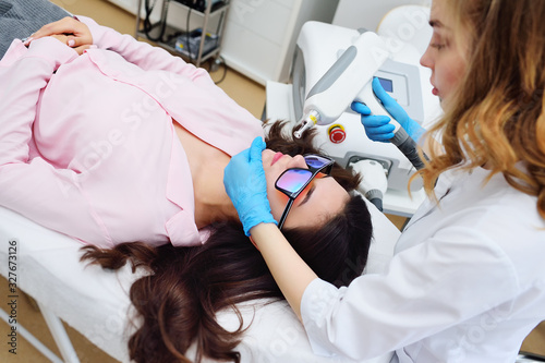 removal of tattoos, pigmentation, moles, vascular asterisks using a neodymium laser in a modern cosmetic dermatological clinic. Hardware cosmetology