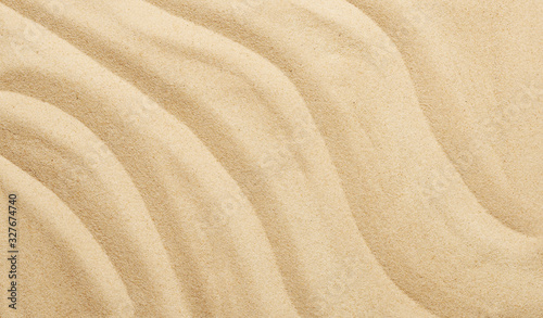 Tropical sand background with sand waves. Sandy beach texture. Top view