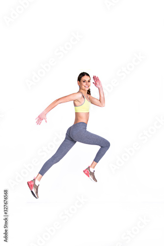 soft focus of Fit girl jumps running , smiling isolated on white