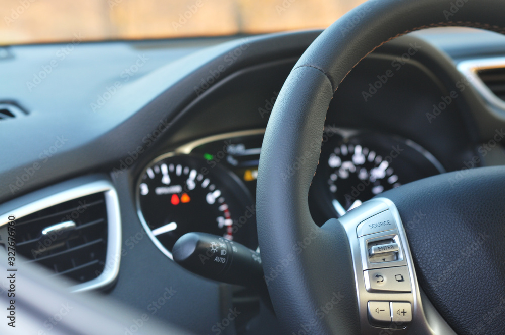 Close-up of a steering wheel and a dashboard