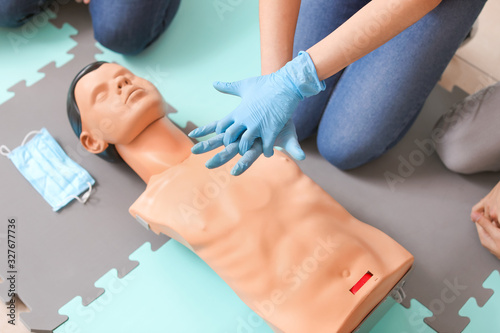 Obraz na płótnie Instructor demonstrating CPR on mannequin at first aid training course