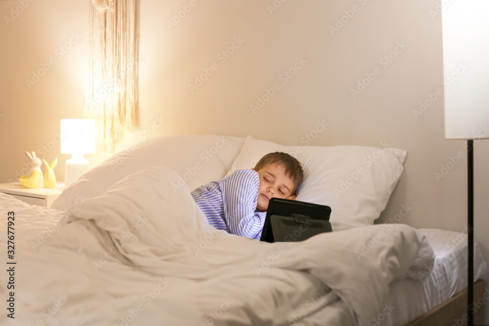 Cute little boy sleeping in bed after watching cartoons Cute little boy sleeping in bed after watching cartoons