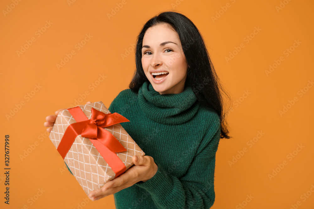 Beautiful young woman with gift on color background Beautiful young woman with gift on color background