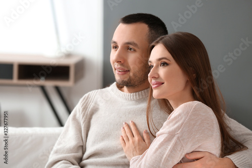 Beautiful young couple watc...
