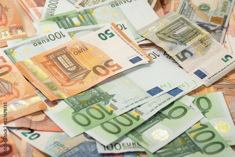 Background of dollar, euro banknotes on a table Background of dollar, euro banknotes on a table