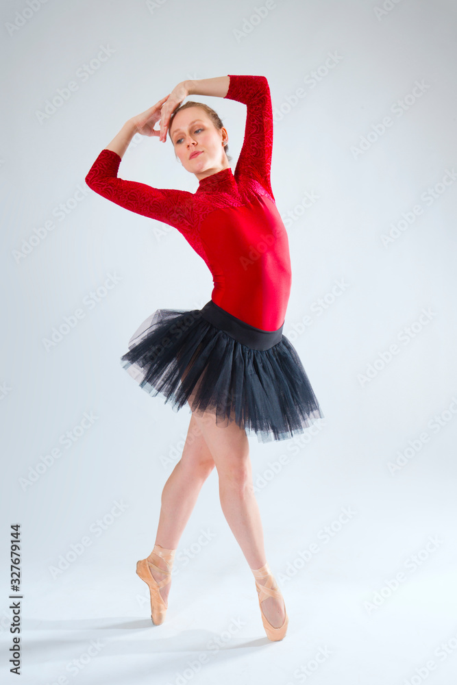 Young woman ballet dancer in red leotard and black tutu. Young woman ballet dancer in red leotard and black tutu.