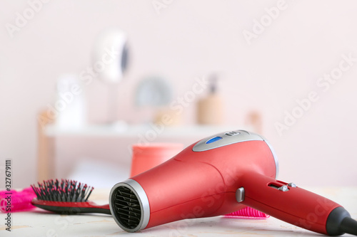 Modern hair dryer on table in salon