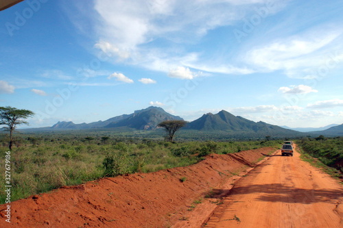 Car with tourists and landscape of the African savanna and the mountain in the background in Kenya in Africa.