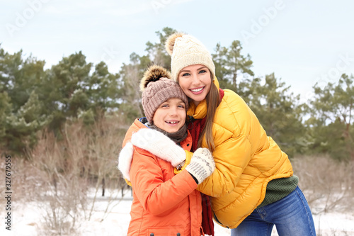 Mother with little son in park on winter day