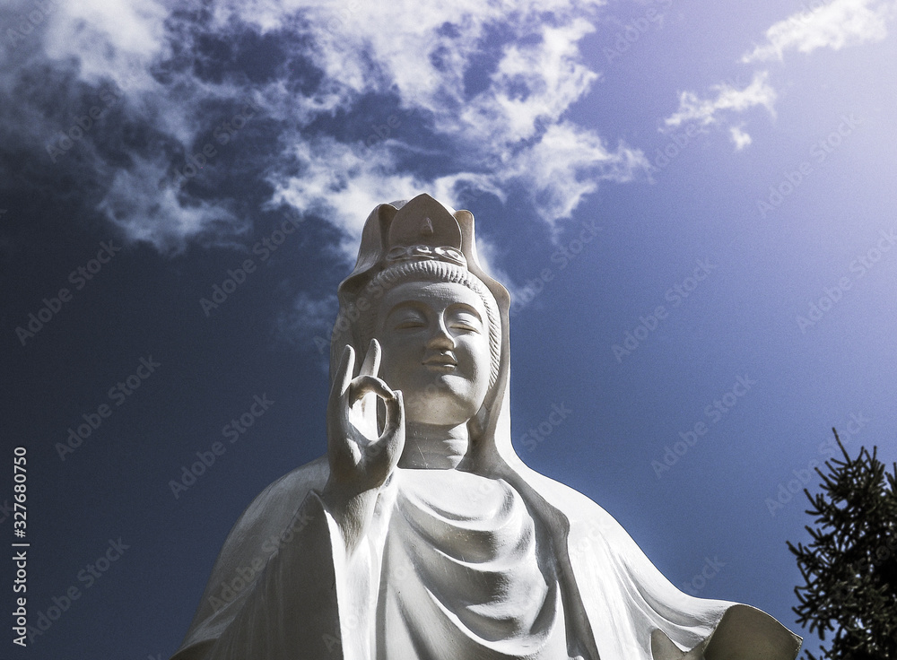 Spectacular cloud over the statue of GuanYin, the Goddess of Mercy and Compassion in the buddhist religion Spectacular cloud over the statue of GuanYin, the Goddess of Mercy and Compassion in the buddhist religion