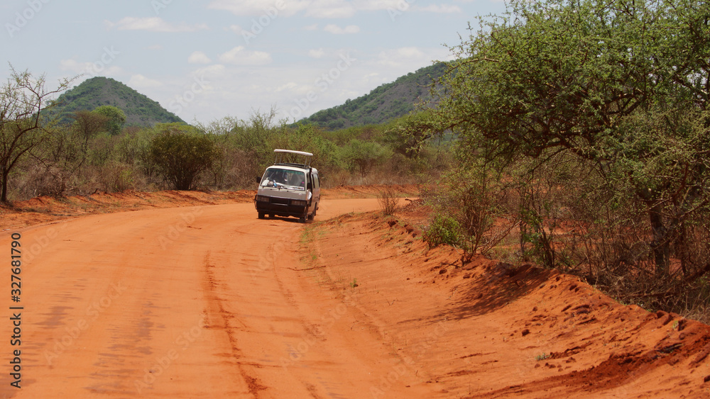 Car with tourists and landscape of the African savanna and the mountain in the background in Kenya in Africa. Car with tourists and landscape of the African savanna and the mountain in the background in Kenya in Africa.
