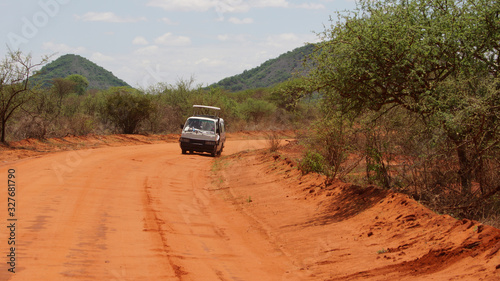 Car with tourists and landscape of the African savanna and the mountain in the background in Kenya in Africa.