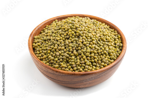 Wooden bowl with raw green mung bean isolated on white background. Side view.