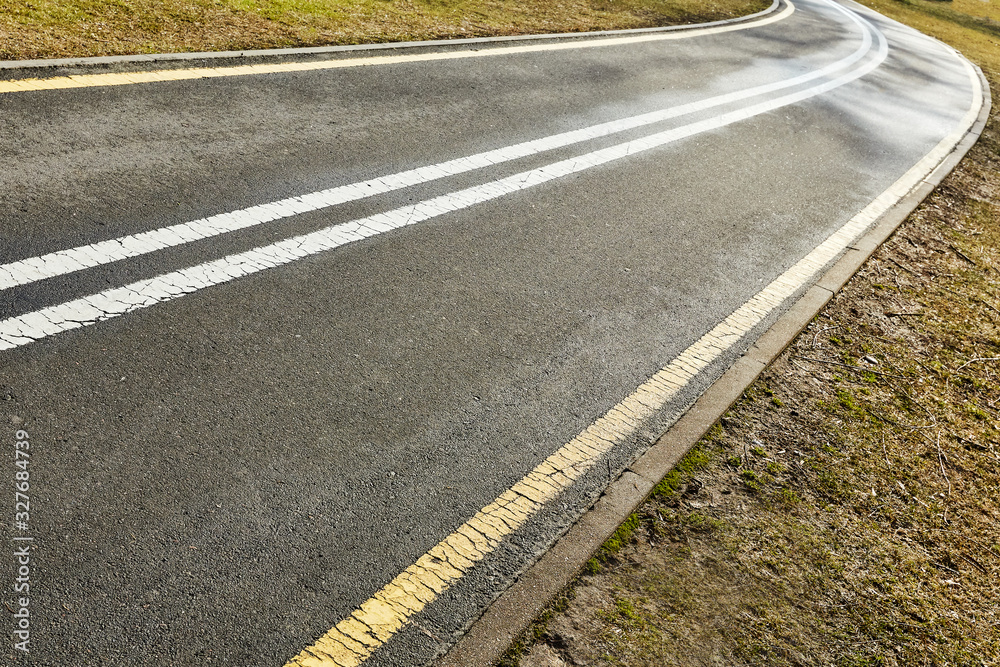 Fototapeta premium yellow and white asphalt bike path