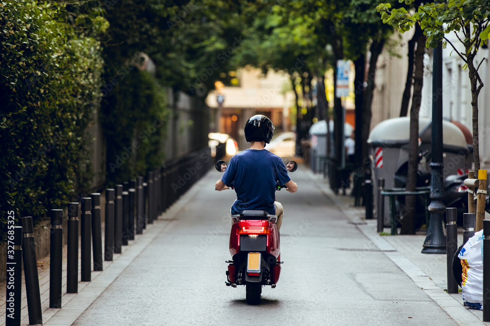photo of boy's back driving his red motorcycle photo of boy's back driving his red motorcycle