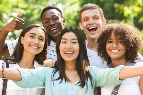 Fotografija Group of multi-ethnic teen friends taking selfie picture outdoors
