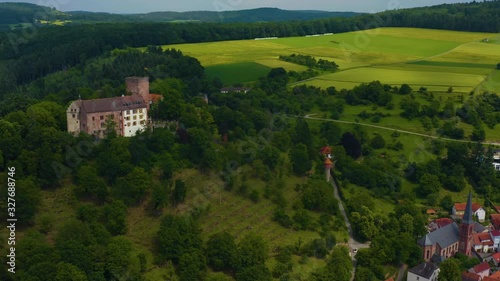 Aerial view of the  village and castle Gamburg in Germany. Pan to the right and zoom out revealing the village beside the castle. photo