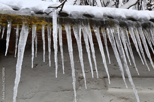  Icicles hanging from the roof of the house are a danger.