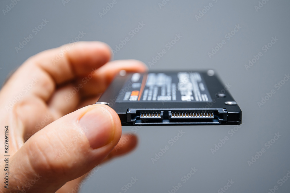 Paris, France - May 18, 2019: man hand holding new SSD Solid state ...