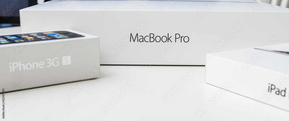 LONDON, UNITED KINGDOM - JAN 14, 2015: Table with cardboard box unboxing of  new Apple MacBook Pro laptop computer, iPad tablet and iphone smartphone  Stock Photo | Adobe Stock