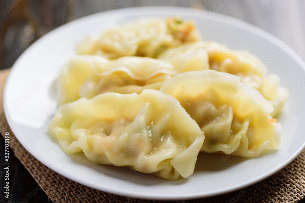 Steamed wonton dumpling stuffed with minced pork and shrimp, Asian cuisine Steamed wonton dumpling stuffed with minced pork and shrimp, Asian cuisine