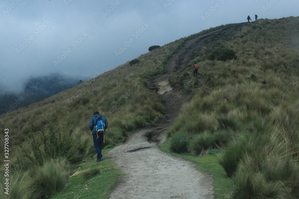 A lone hiker walking over a path in the Andes in the teleferico near quito