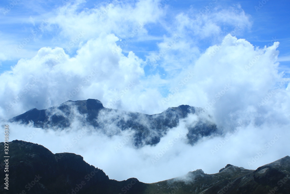 An empty mountain ridge in the andes of Ecuador near quito with a stunning cloudscape and bright blue sky