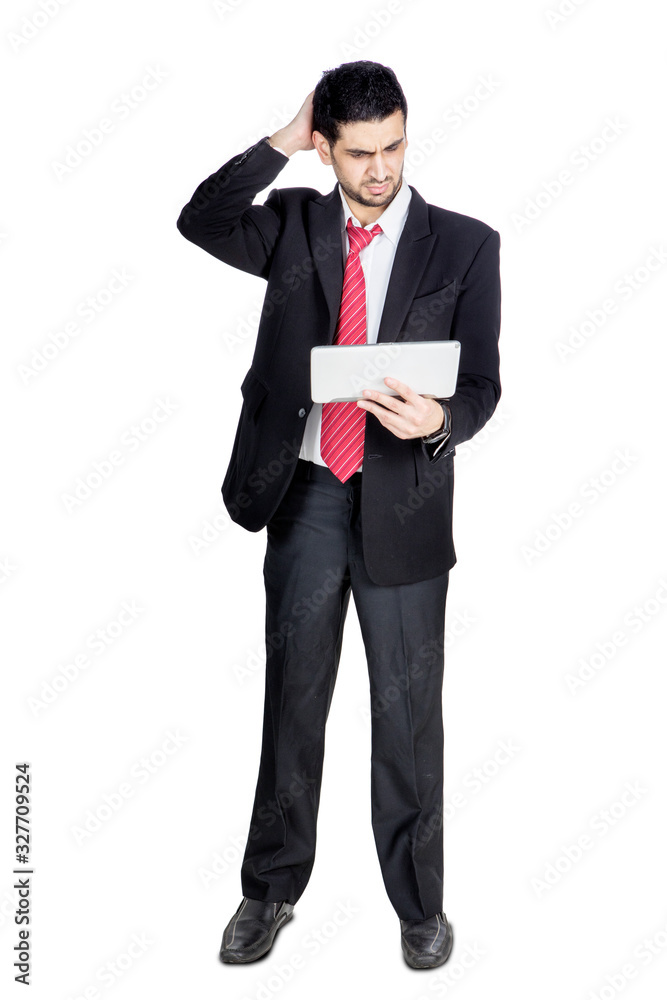 Businessman looks confused with his digital tablet Businessman looks confused with his digital tablet