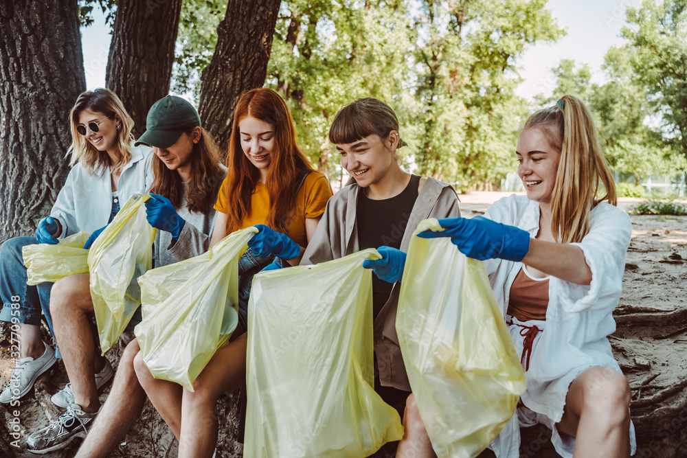 Group of activists friends collecting plastic waste at the park. Environmental conservation. Group of activists friends collecting plastic waste at the park. Environmental conservation.