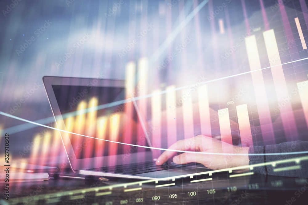 Double exposure of stock market graph with man working on laptop on background. Concept of financial analysis.