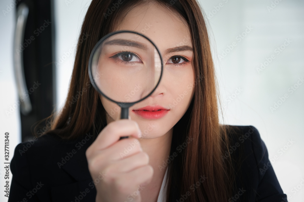 Business woman using magnifying to using audit or scan concept. Business woman using magnifying to using audit or scan concept.