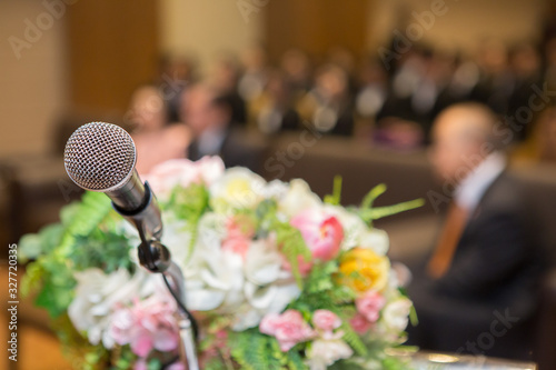 Microphone on the podium and People in  the seminar room