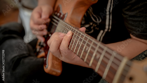 Cropped shot of male musician playing guitar in music instrument