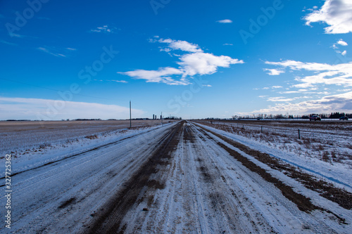 Vanishing point - Gravel road on the prairies in winter, Alberta, Canada © Garry