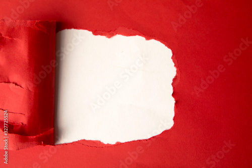 Flat layout of a hole from torn red cardboard