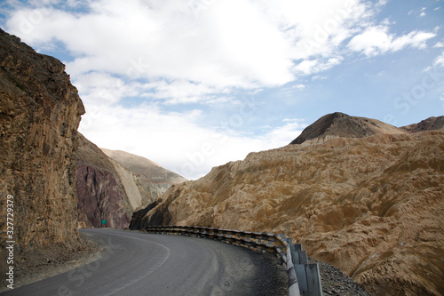Asphalt road in the Himalayas mountains, driving through the rocks. High mountain range. Typical scenery for Northern India Ladakh, Pakistan, Afghanistan, Tibet