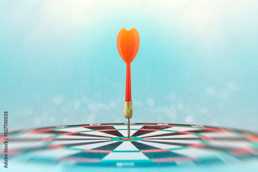 A dart in the center of the target. Competition for accuracy. Soft toning of the image. Background blurring, bokeh. A dart in the center of the target. Competition for accuracy. Soft toning of the image. Background blurring, bokeh.