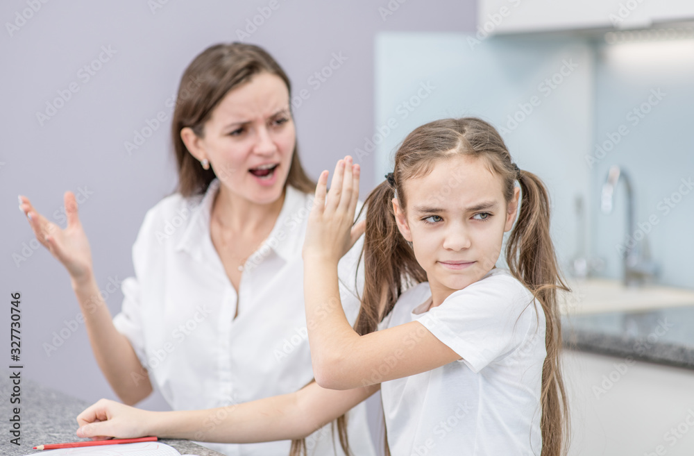 Mother scolds her teenage daughter, girl ignoring her mom and shows stop gesture. Family relationships Mother scolds her teenage daughter, girl ignoring her mom and shows stop gesture. Family relationships