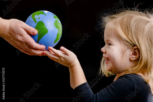 фотографія Mother gives the planet into the hands of a child