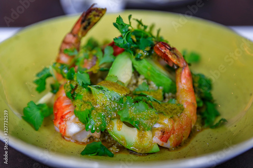Grilled shrimp salad with quinoa, avocado and parsley on a plate at a luxury restaurant in Nice, France