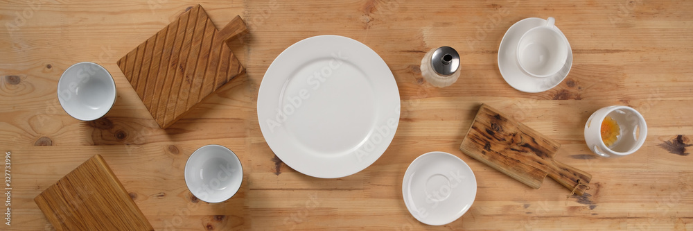 Crockery on a wooden table. Empty dishes. Picnic concept. Copy space top view. Flat lay. Banner. Crockery on a wooden table. Empty dishes. Picnic concept. Copy space top view. Flat lay. Banner.