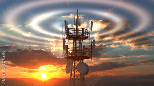 Cellular telecommunications tower with radio waves visible against scenic sunset sky. Modern cellular telecommunications towers can cover a wide range of network technologies including modern 4G 5G